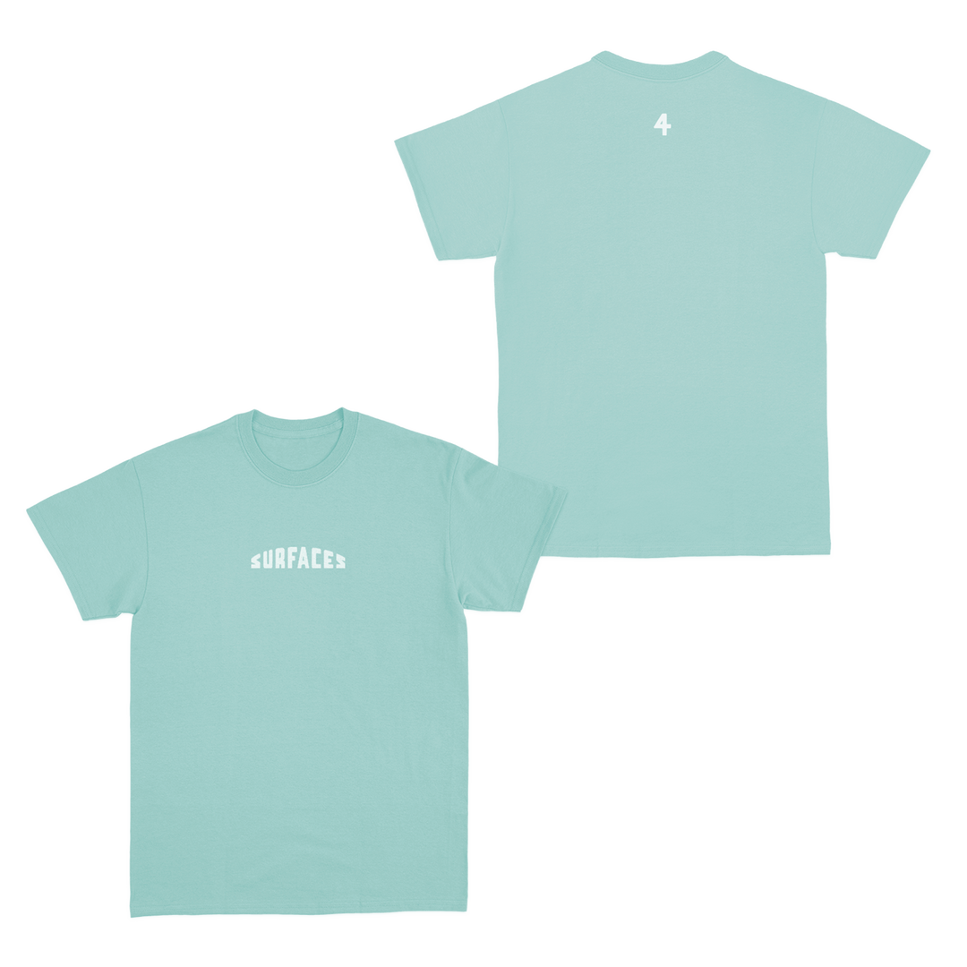 Green t-shirt with the word Surfaces on the front and the number 4 small on the back just beneath the back collar